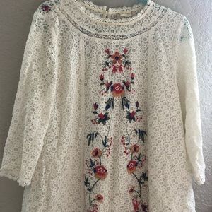 A white blouse w/ embroidery pattern